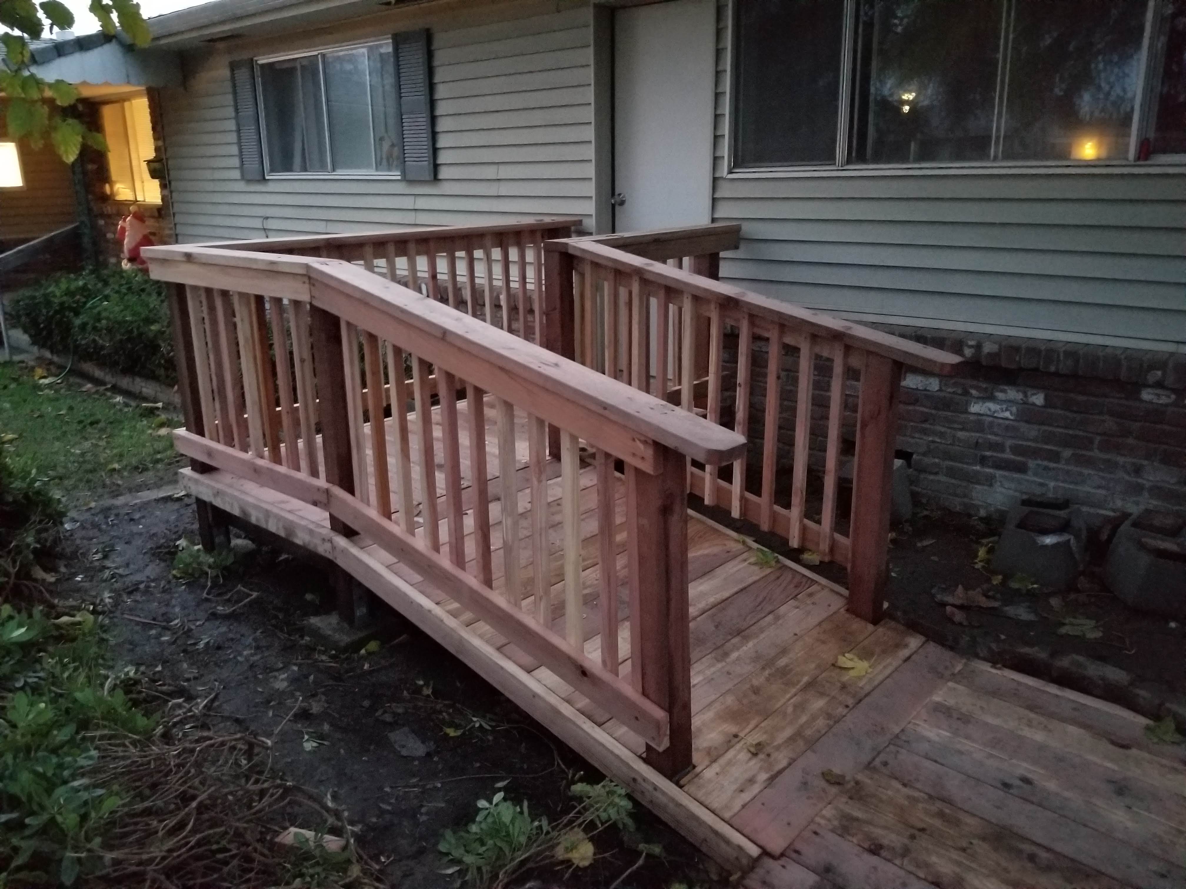 Redwood entry ramp with railings to a house door