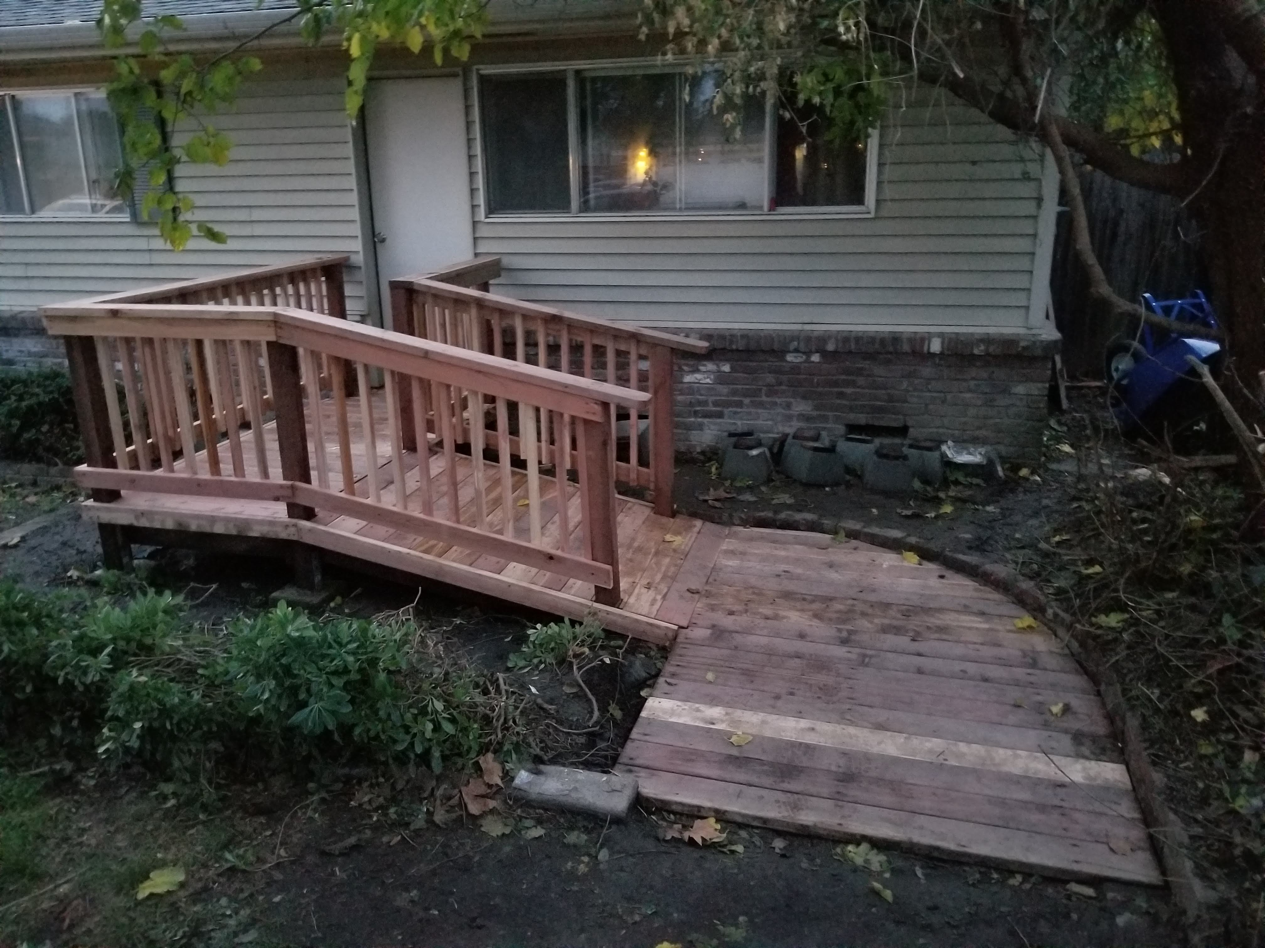 Redwood entry deck and ramp with a plank walkway