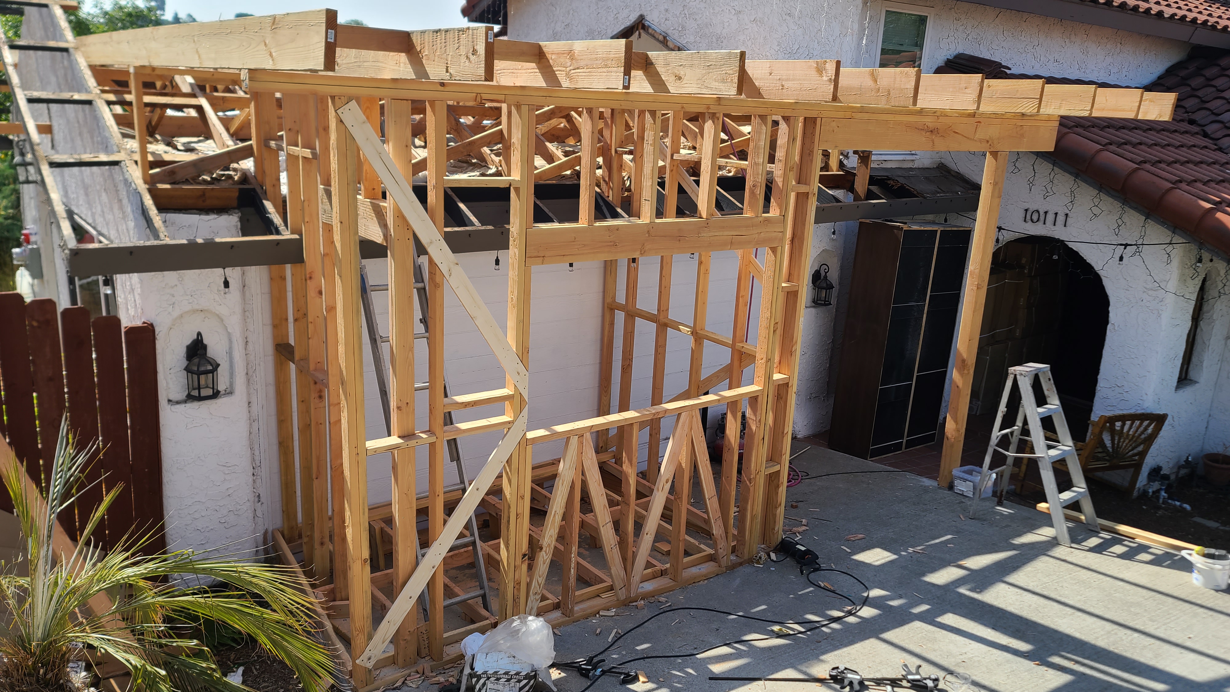 Wood wall and roof framing for a patio addition